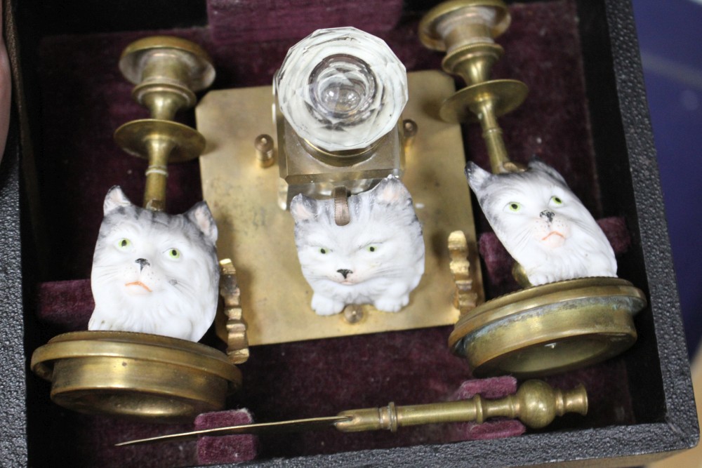 A group of assorted ornaments all relating to cats, comprising: boxed four piece desk set, a painted spelter three cat ornament, two fu